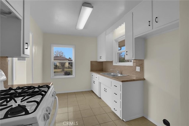 kitchen featuring white cabinets, tasteful backsplash, and sink