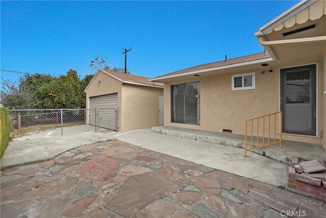 exterior space featuring a garage and an outdoor structure