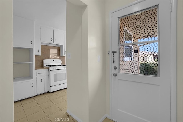 doorway to outside with light tile patterned flooring