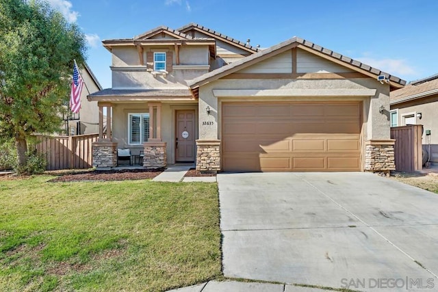 craftsman house featuring a garage and a front lawn