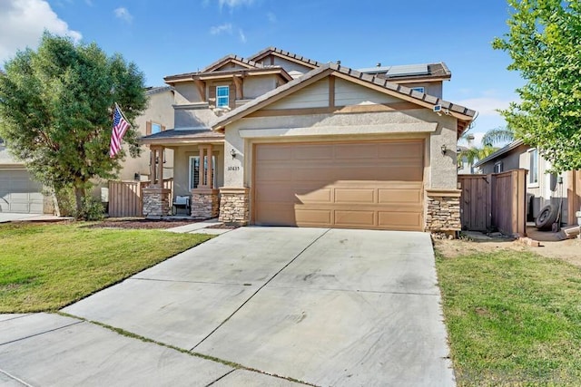 view of front of home with a front lawn, a garage, covered porch, and solar panels