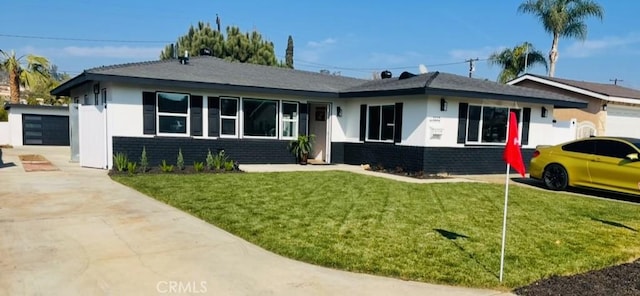 ranch-style home with a garage and a front lawn