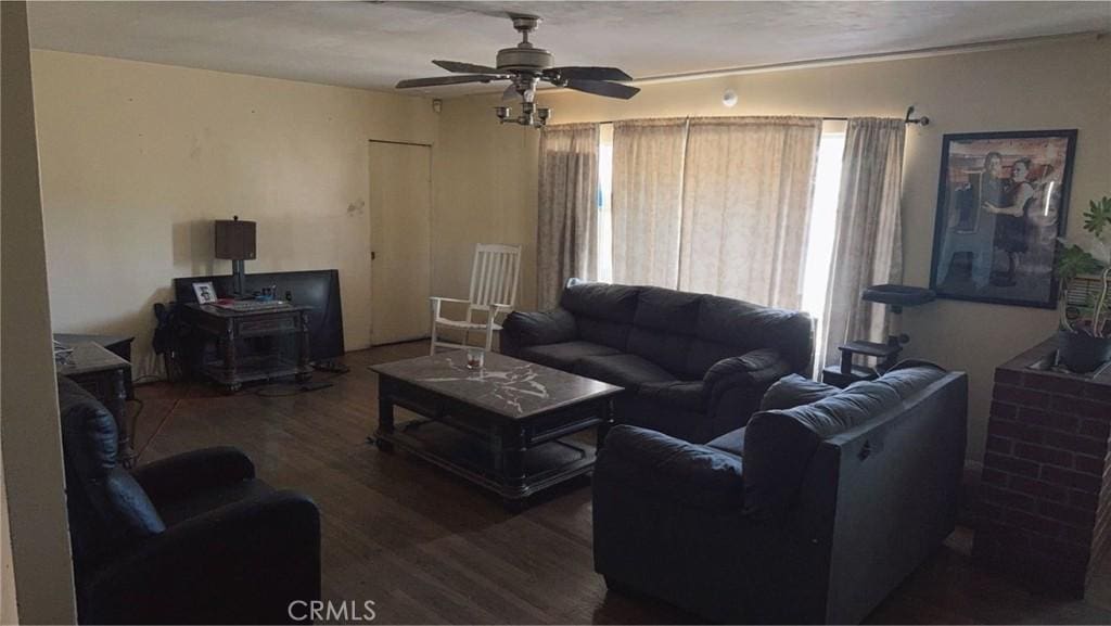 living room with dark hardwood / wood-style floors and ceiling fan