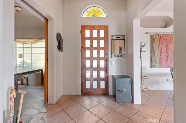 foyer with a healthy amount of sunlight and light tile patterned floors