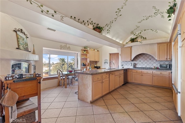 kitchen featuring kitchen peninsula, light tile patterned floors, lofted ceiling, and light brown cabinets