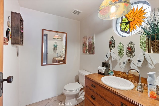 bathroom with tile patterned floors, vanity, and toilet