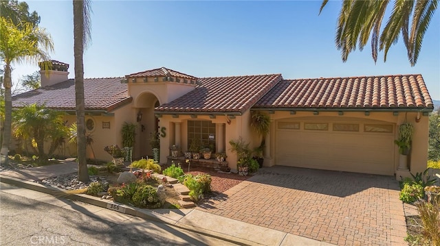 mediterranean / spanish-style home featuring a garage