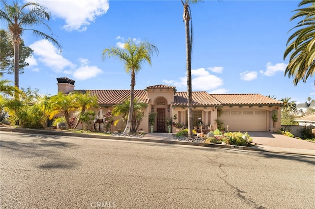 mediterranean / spanish house featuring a garage