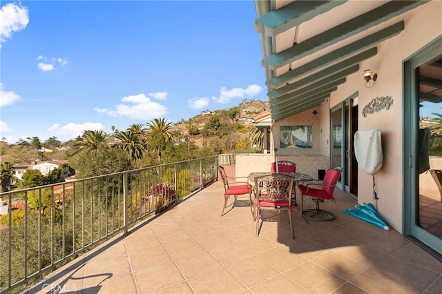 view of patio featuring a balcony