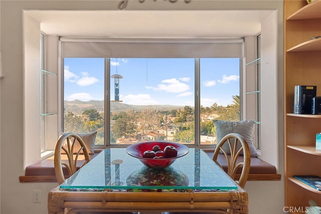 dining room with plenty of natural light and a mountain view