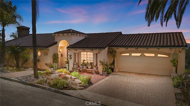 mediterranean / spanish-style home featuring a garage