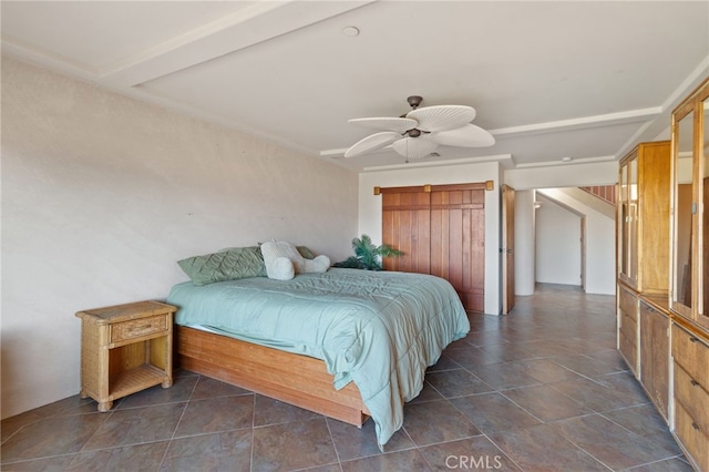 bedroom with ceiling fan and beamed ceiling