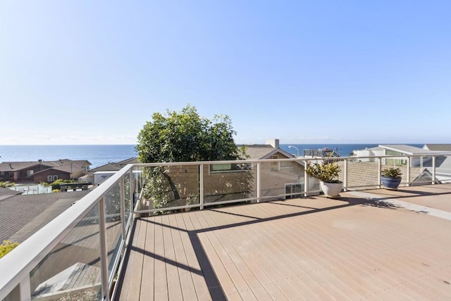 wooden terrace featuring a water view