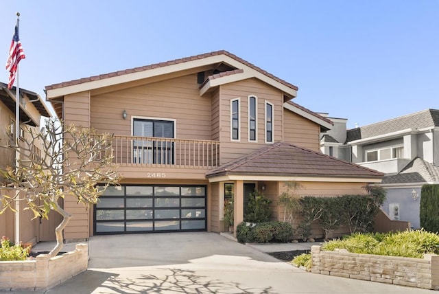 view of front of property with a garage and a balcony