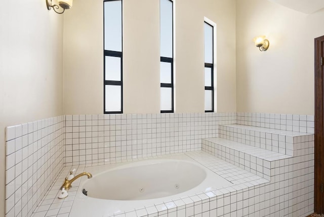 bathroom with tiled bath and plenty of natural light