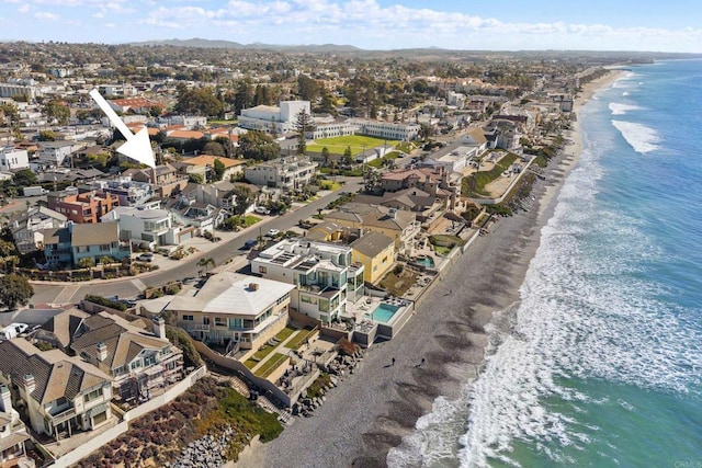 birds eye view of property featuring a view of the beach and a water view