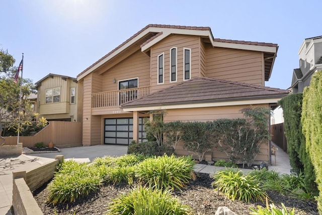 view of property with a balcony and a garage