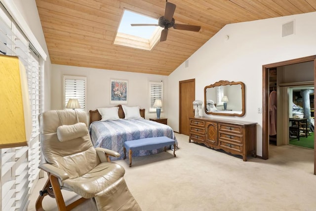 bedroom featuring ceiling fan, light colored carpet, vaulted ceiling with skylight, and wooden ceiling