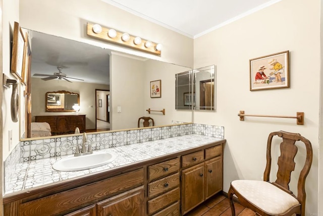 bathroom with ceiling fan, crown molding, and vanity