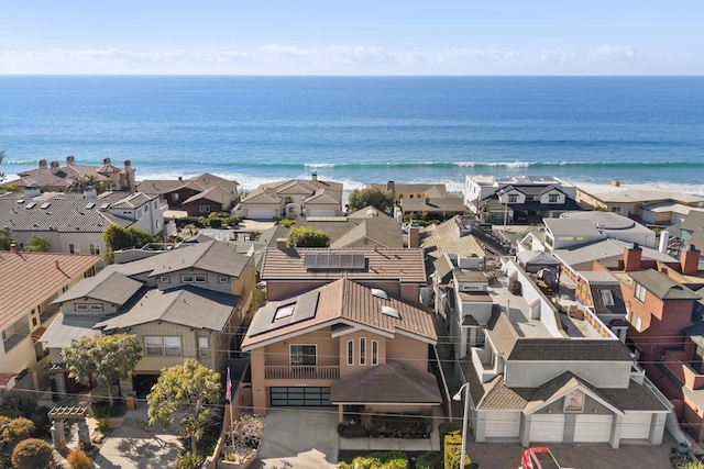 birds eye view of property with a view of the beach and a water view