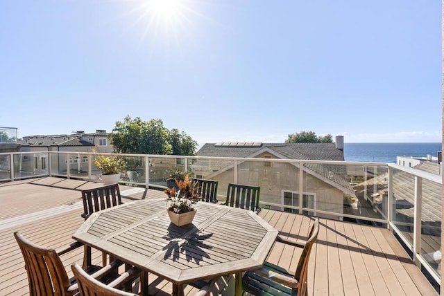 wooden terrace featuring a water view