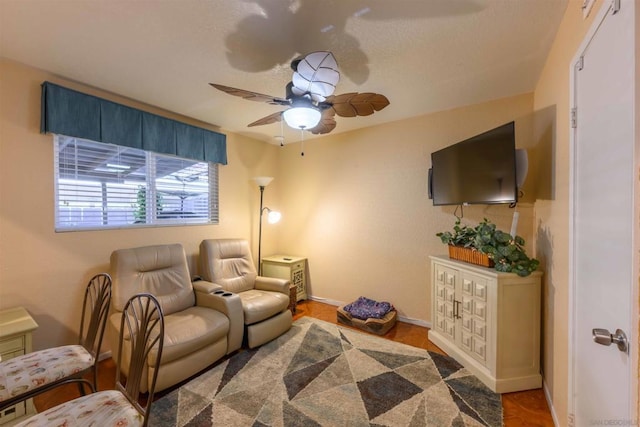 living room featuring ceiling fan and hardwood / wood-style floors