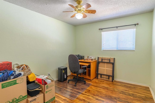 office space with ceiling fan, dark hardwood / wood-style flooring, and a textured ceiling