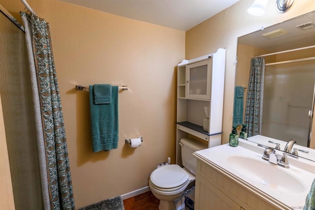 bathroom featuring toilet, walk in shower, and vanity