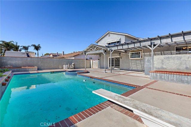 view of pool featuring a patio area, a diving board, and an in ground hot tub