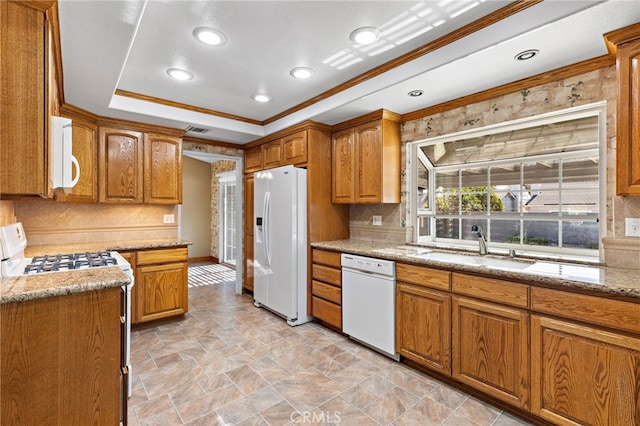 kitchen featuring sink, white appliances, ornamental molding, light stone countertops, and decorative backsplash