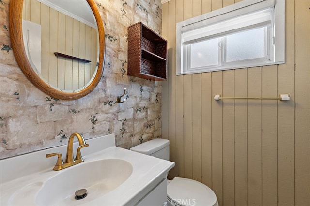 bathroom featuring vanity, crown molding, and toilet