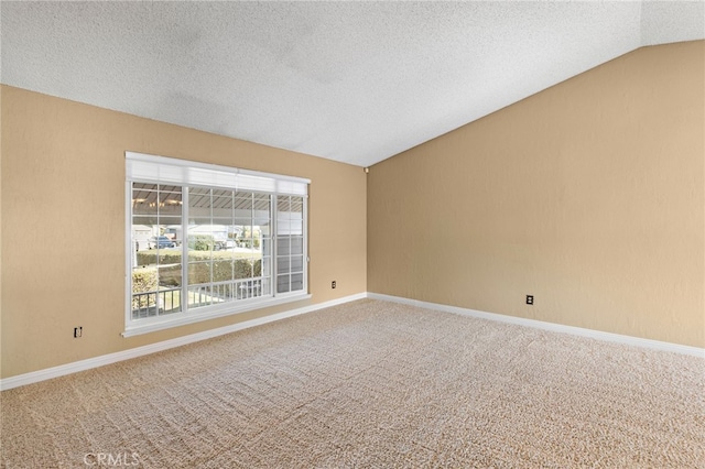 carpeted empty room with lofted ceiling and a textured ceiling