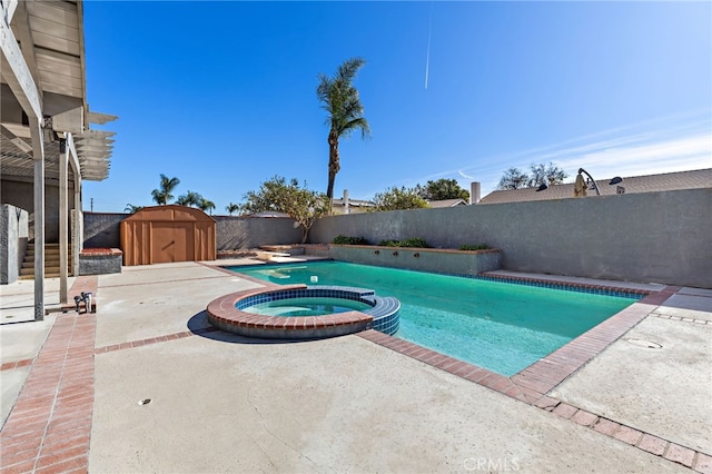 view of pool featuring a patio area, a storage unit, and an in ground hot tub