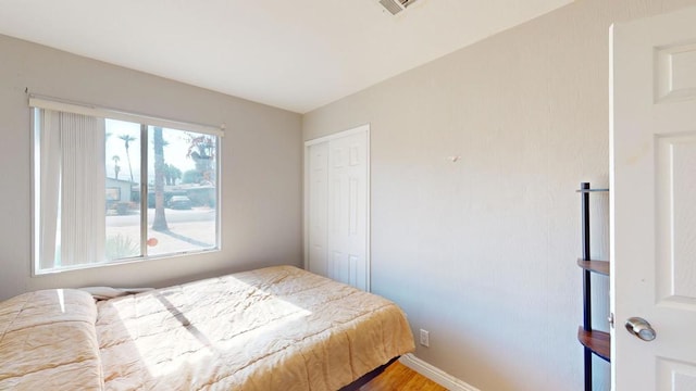 bedroom with hardwood / wood-style flooring and a closet