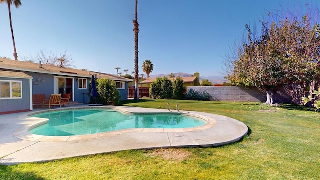 view of swimming pool with a lawn and a patio area