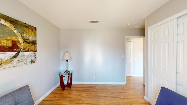 corridor with light hardwood / wood-style flooring