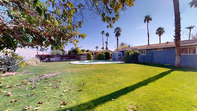 view of yard with a fenced in pool