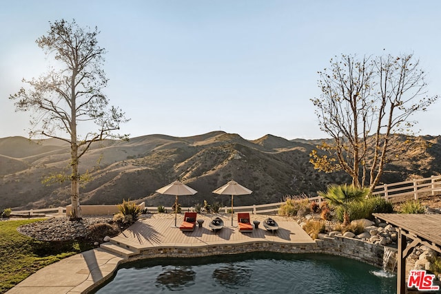 view of pool featuring a deck with mountain view