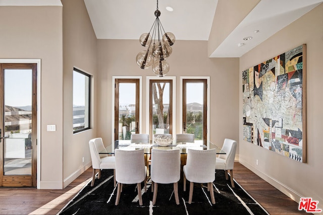 dining area with dark wood-type flooring and a chandelier