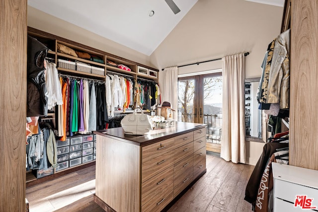 walk in closet featuring high vaulted ceiling, french doors, dark hardwood / wood-style flooring, and ceiling fan