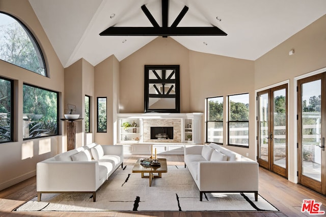 living room with light wood-type flooring, a fireplace, french doors, high vaulted ceiling, and beam ceiling