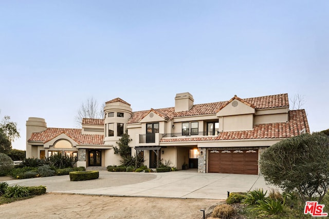 mediterranean / spanish house with a garage