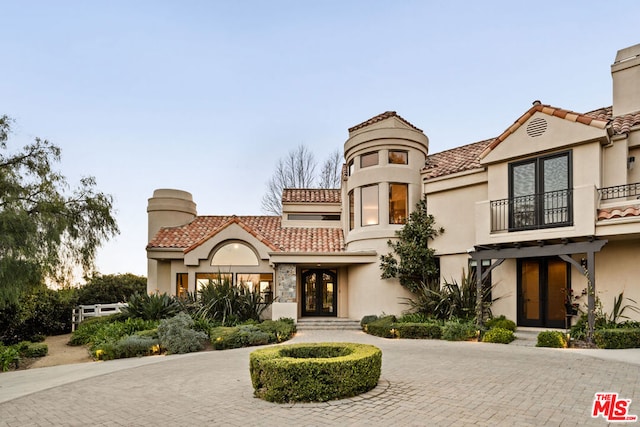 mediterranean / spanish-style home with a balcony