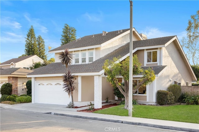 view of front of property with a garage and a front yard