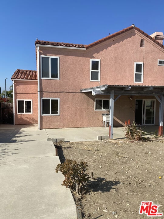 rear view of property featuring a patio area