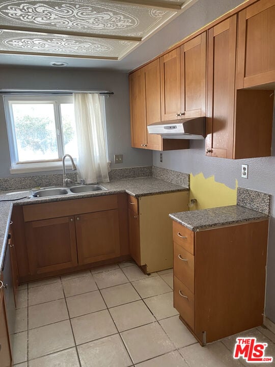 kitchen with light tile patterned flooring and sink