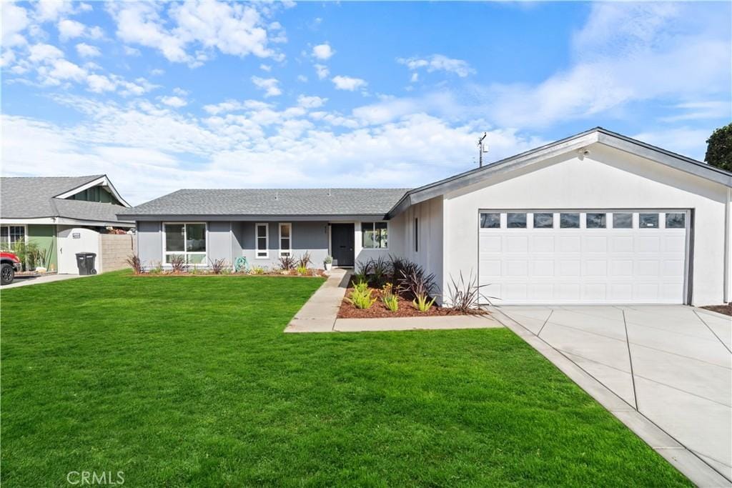 single story home with a front yard and a garage