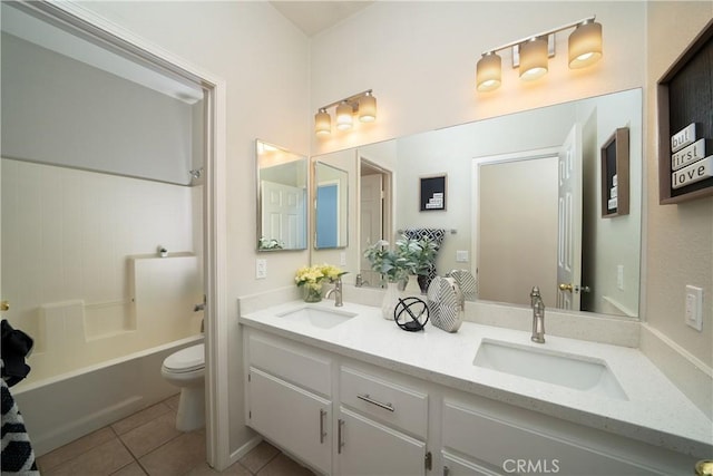 bathroom with toilet, bathing tub / shower combination, a sink, and tile patterned floors