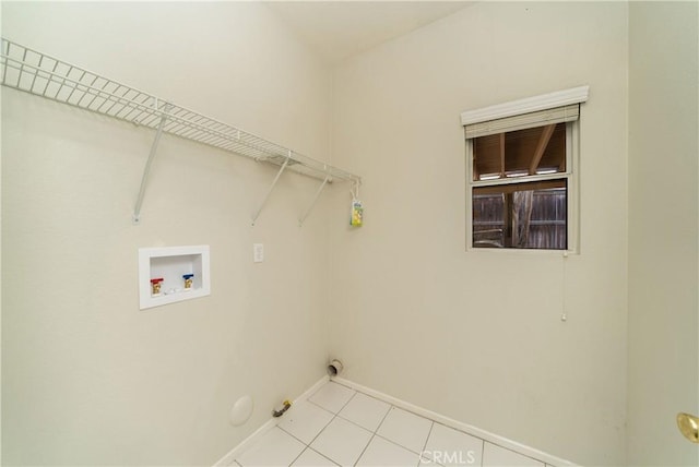 washroom featuring laundry area, light tile patterned floors, baseboards, hookup for a gas dryer, and hookup for a washing machine