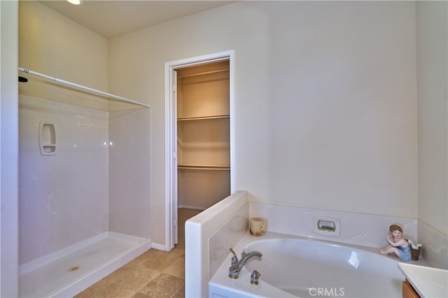 bathroom with shower with separate bathtub